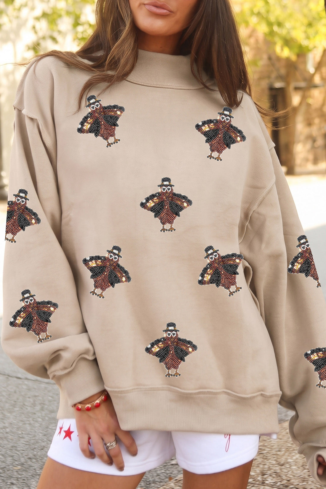 Apricot Sequin Turkey Graphic Mock Neck Exposed Seam Pullover Sweatshirt